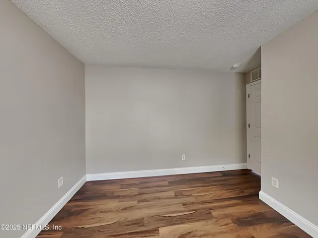 a view of room with wooden floor