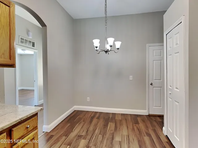 a view of livingroom with hallway and wooden floor