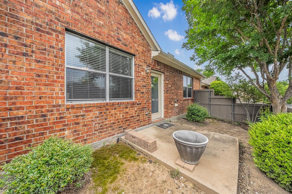 7253 Bianca Lane Plano, TX 75093 - Photo 14 of 18 a backyard of a house with table and chairs and potted plants