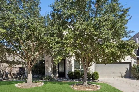 front view of a building with a tree