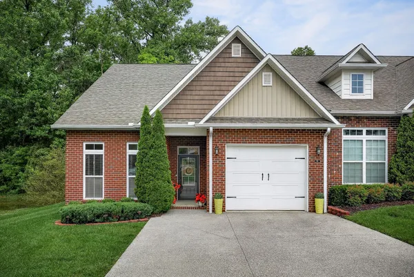 a view of a house with a yard and garage