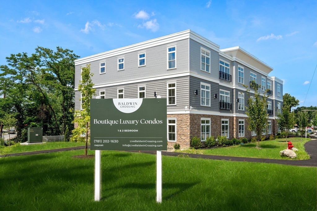 7 Cross Street, Unit 304 Wilmington, MA 01887 - Photo 15 of 19 a front view of a building with play ground