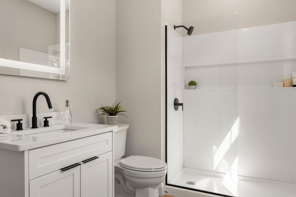 7 Cross Street, Unit 304 Wilmington, MA 01887 - Photo 9 of 19 a bathroom with a sink toilet and a shower