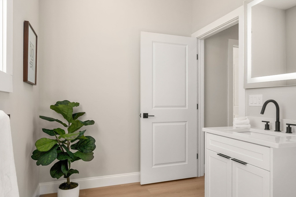7 Cross Street, Unit 304 Wilmington, MA 01887 - Photo 10 of 19 a view of a hallway with a potted plant