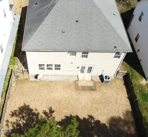 with aerial view of a house with a yard