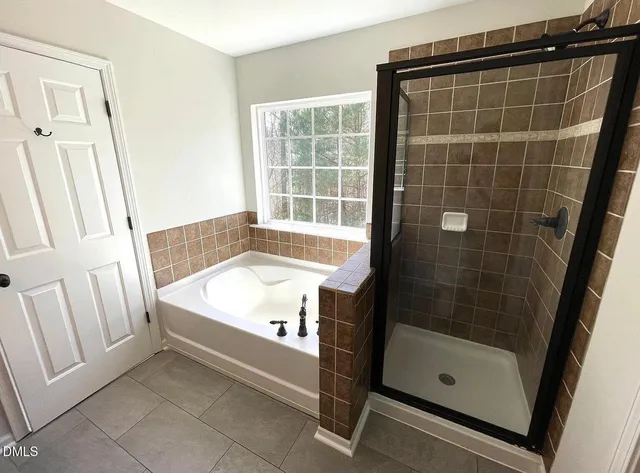a bathroom with a tub and a shower