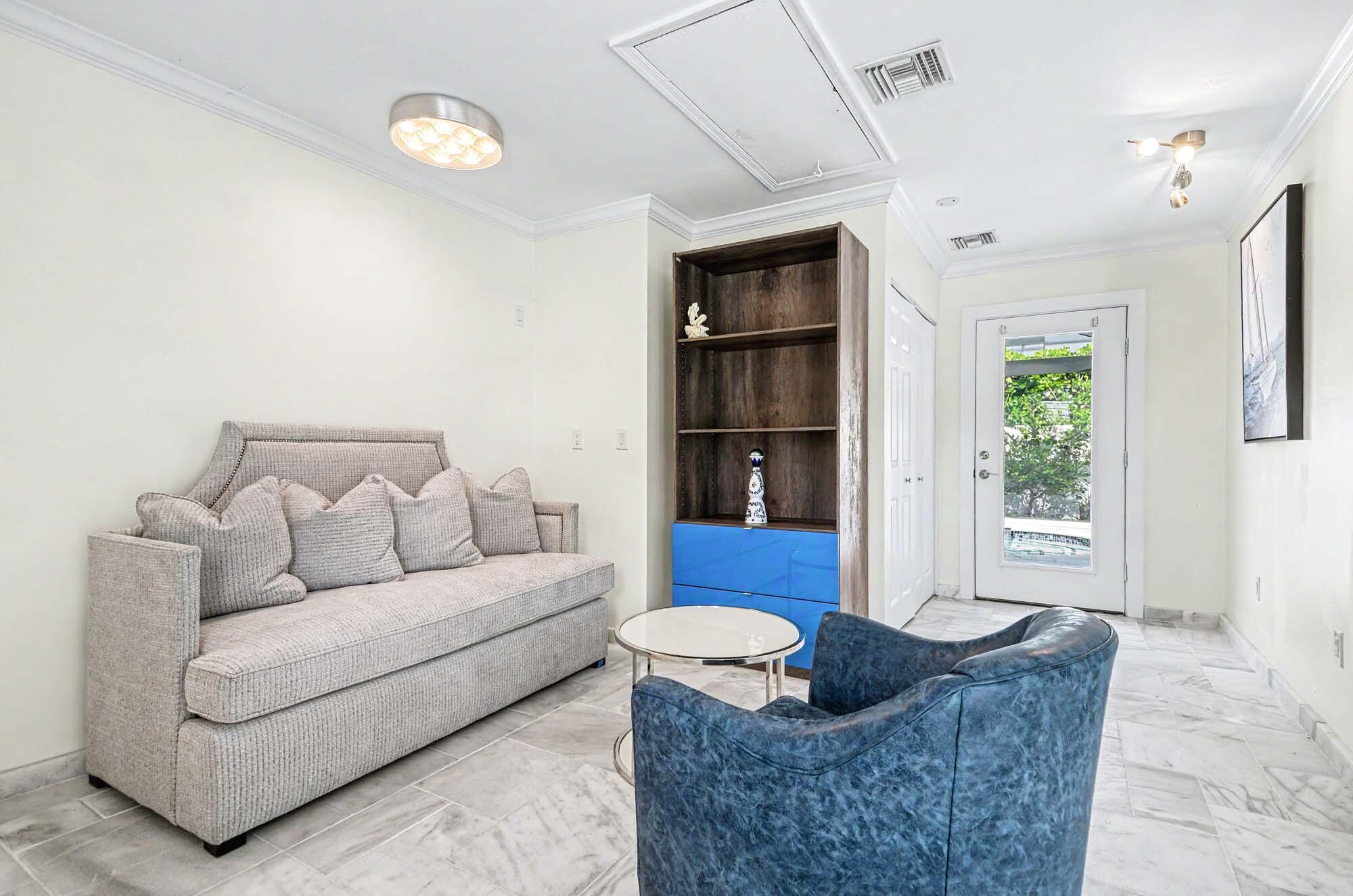 112 Capri Boulevard Naples, FL 34113 - Photo 13 of 29 a living room with furniture and a window