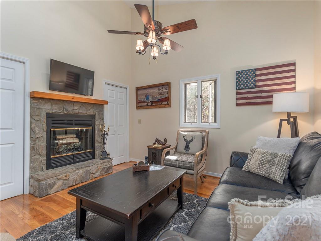 51 Forest Road Canton, NC 28716 - Photo 2 of 26 a living room with furniture a chandelier and a fireplace