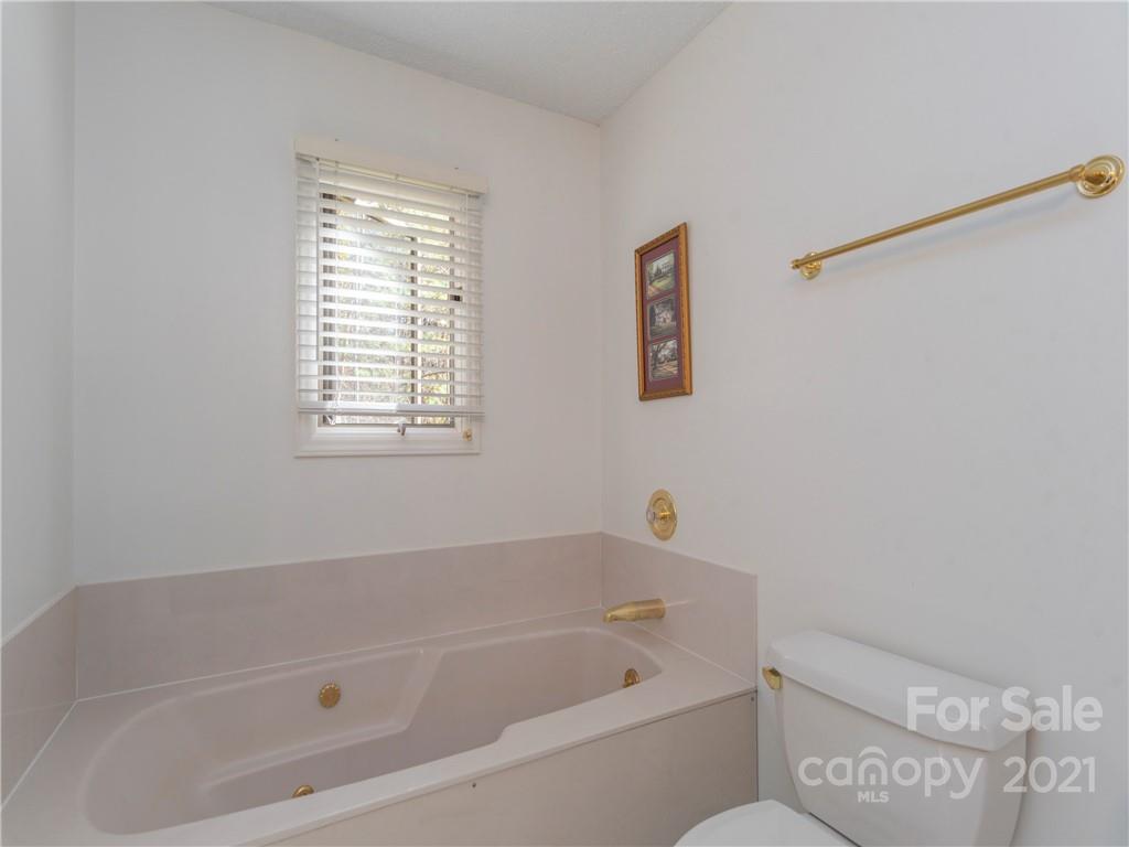 51 Forest Road Canton, NC 28716 - Photo 11 of 26 a white bath tub sitting next to a window