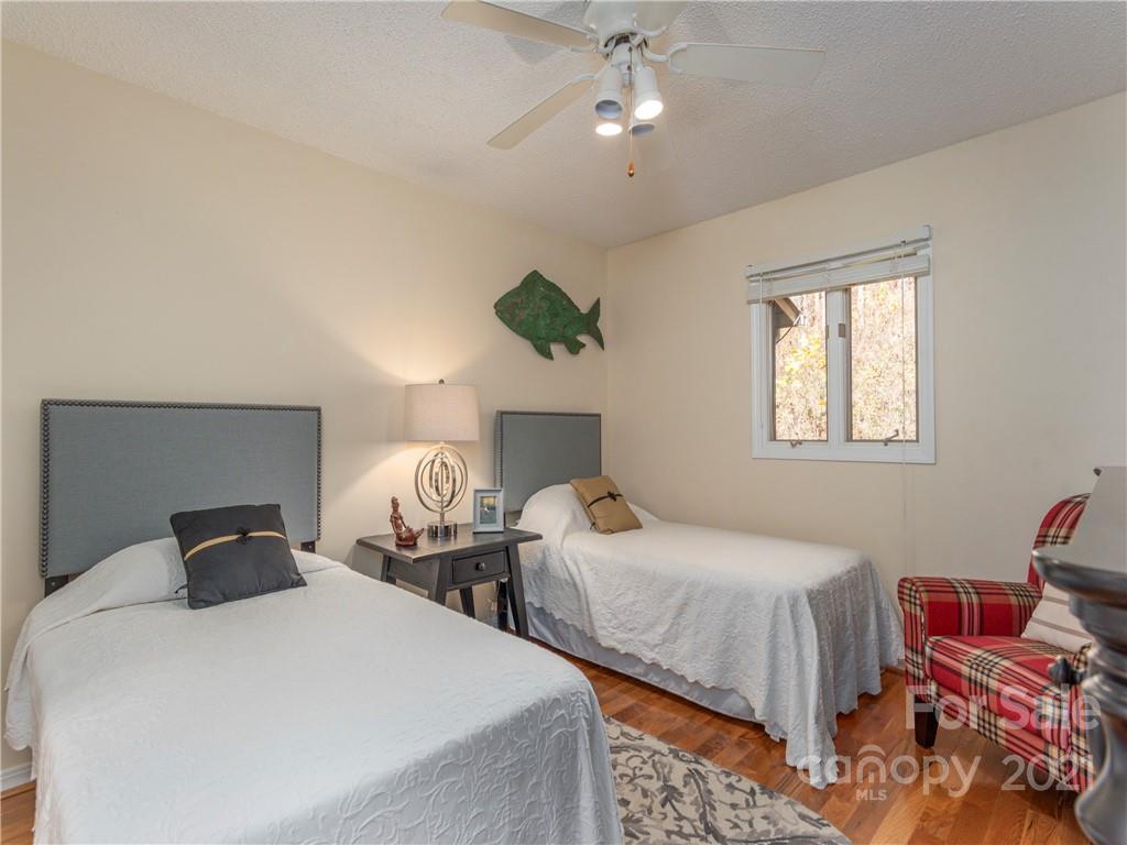 51 Forest Road Canton, NC 28716 - Photo 12 of 26 a bedroom with two beds and a chandelier