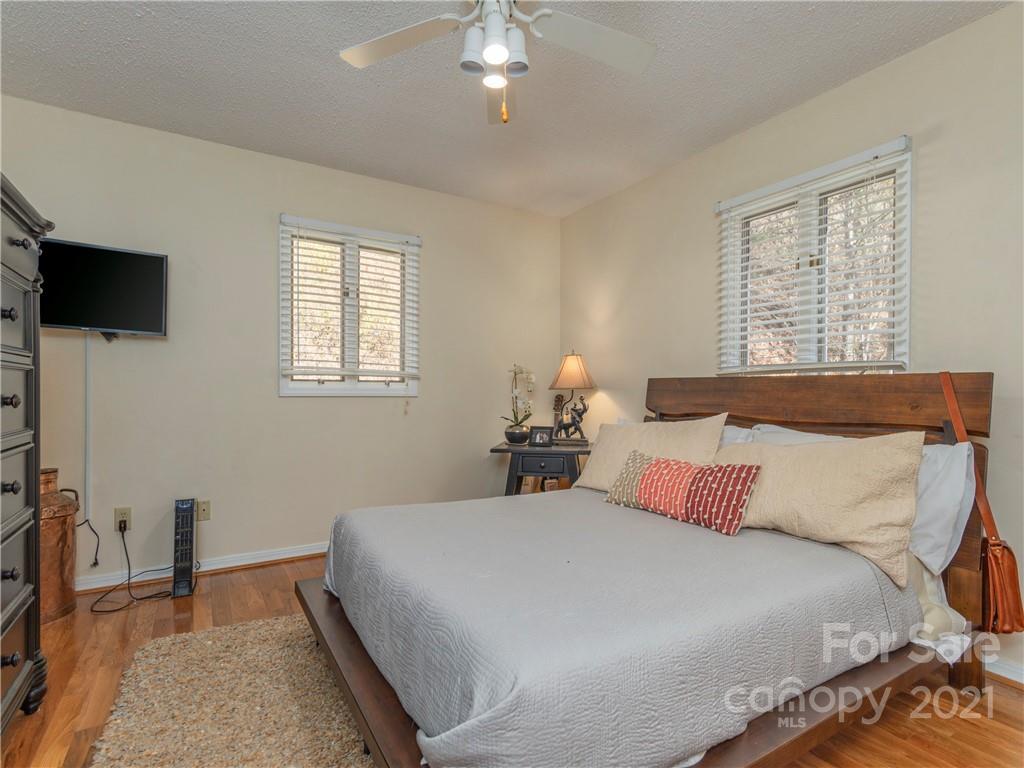 51 Forest Road Canton, NC 28716 - Photo 9 of 26 a bedroom with a bed a flat screen tv and a window