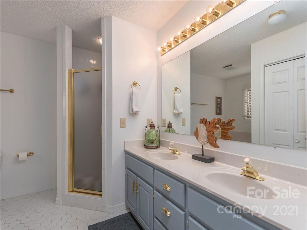 51 Forest Road Canton, NC 28716 - Photo 10 of 26 a bathroom with a granite countertop double vanity sink and a mirror