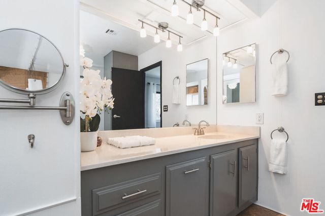 a bathroom with a double vanity sink mirror and vanity