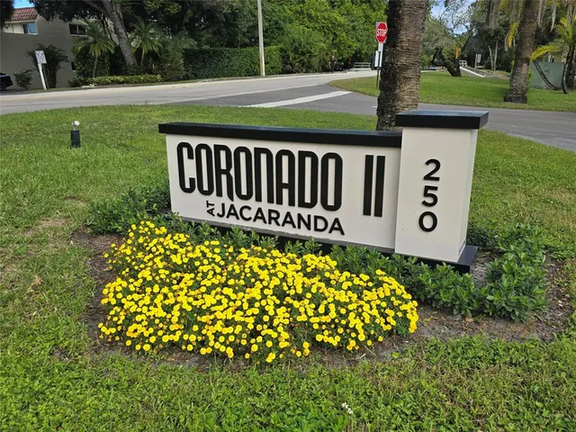 a view of a sign board with garden