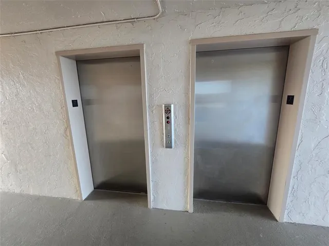 a kitchen with stainless steel appliances granite countertop a sink and a refrigerator