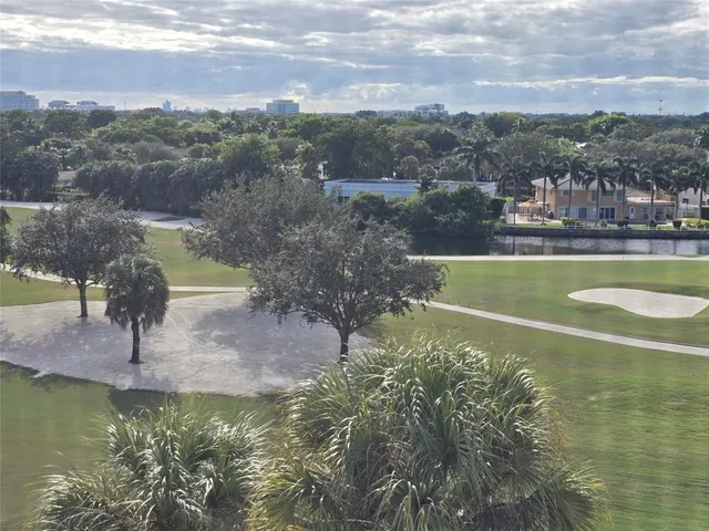 a view of a swimming pool with a patio and a garden