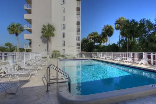 a view of a swimming pool with a lounge chairs