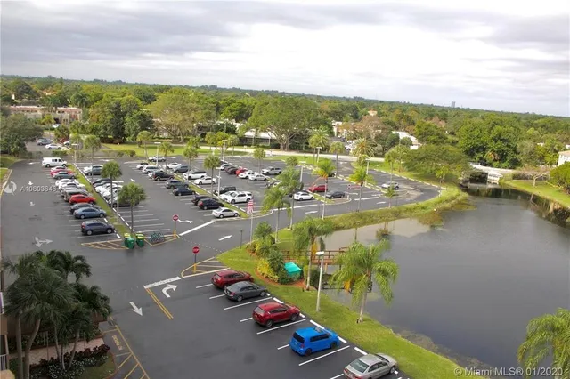 an aerial view of lake residential house with outdoor space and trees around
