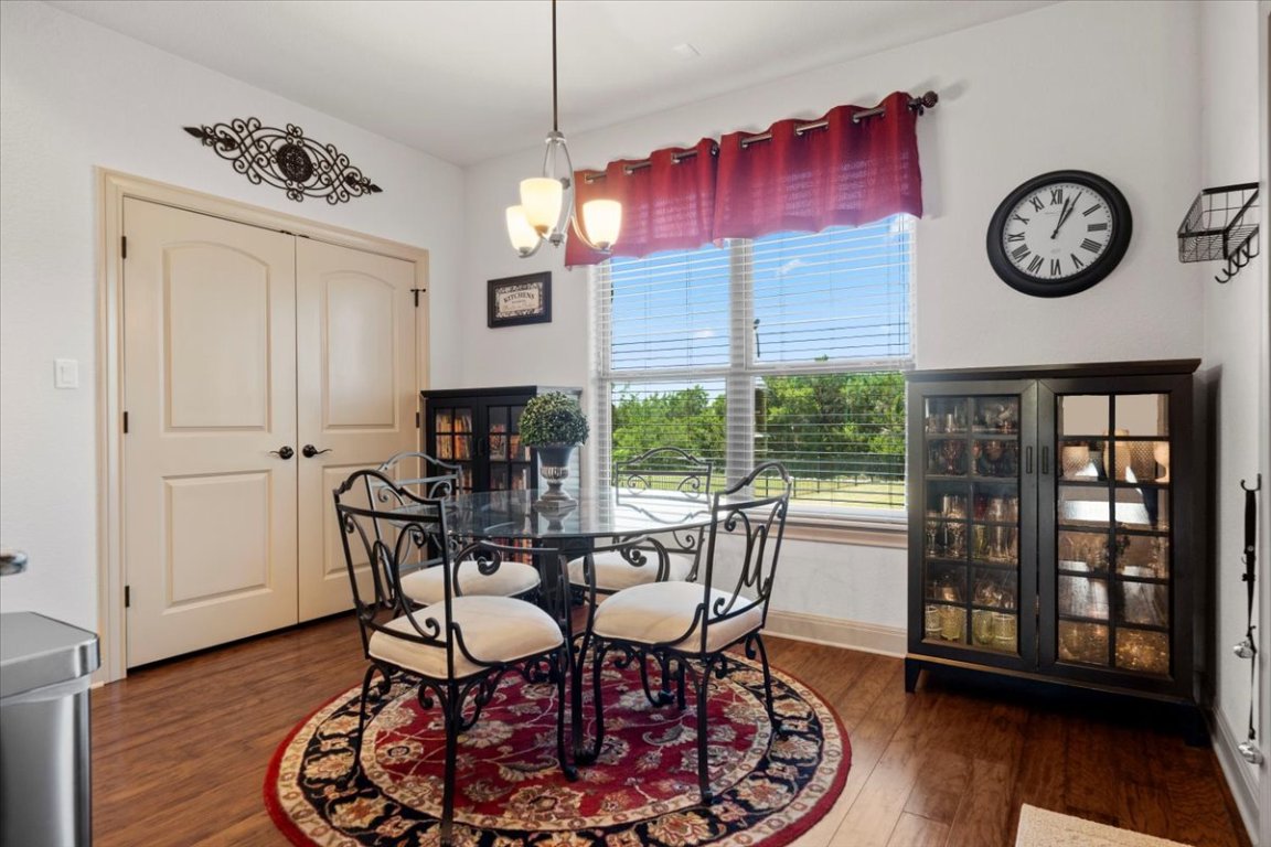 224 Whitney Woods Circle Georgetown, TX 78633 - Photo 17 of 40 a view of a dining room with furniture window and wooden floor
