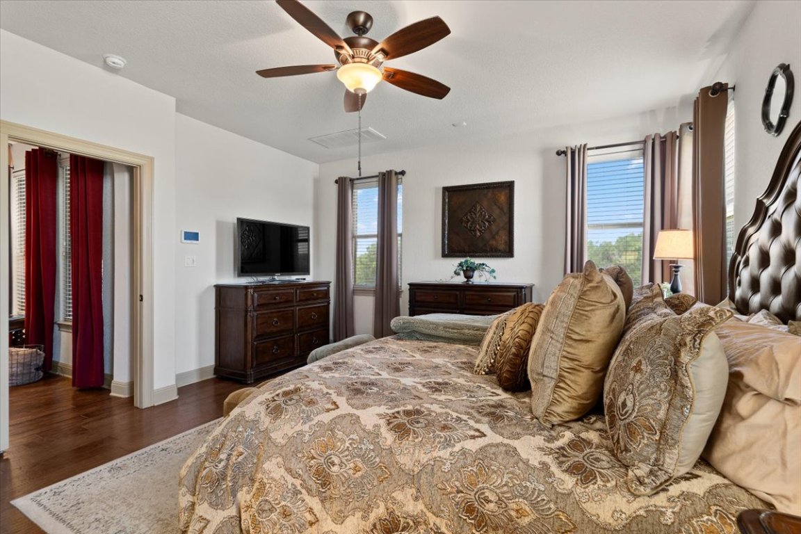 224 Whitney Woods Circle Georgetown, TX 78633 - Photo 19 of 40 a bedroom with a bed and a flat screen tv