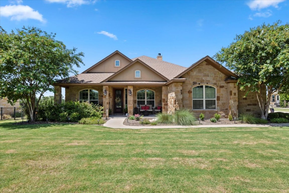 224 Whitney Woods Circle Georgetown, TX 78633 - Photo 2 of 40 a front view of a house with a yard patio and fire pit