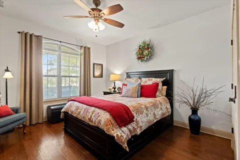a bedroom with a large bed and a chandelier