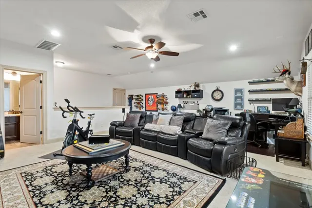 a living room with furniture a rug and a chandelier