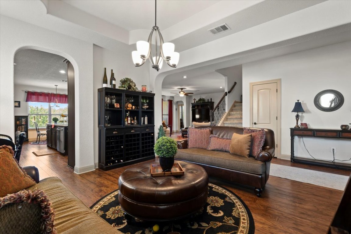 224 Whitney Woods Circle Georgetown, TX 78633 - Photo 5 of 40 a living room with furniture a lamp and a chandelier