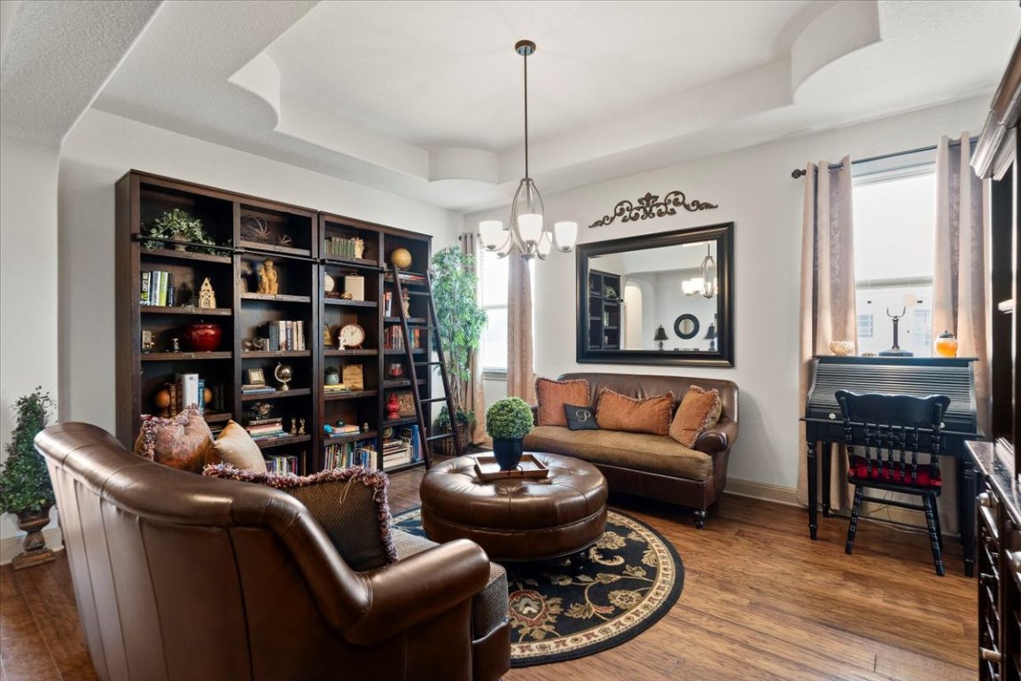 224 Whitney Woods Circle Georgetown, TX 78633 - Photo 6 of 40 a living room with furniture a bookshelf and a window