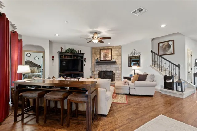 a living room with furniture a fireplace and a flat screen tv