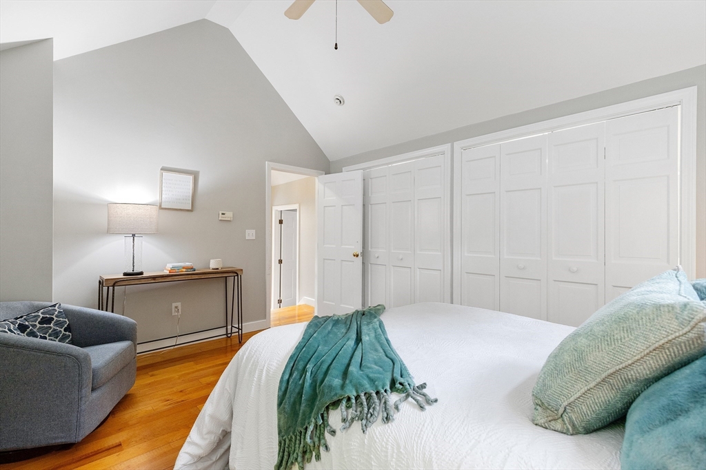 148 Wood Street, Unit 4 Lexington, MA 02421 - Photo 13 of 26 a bedroom with a bed and a chandelier