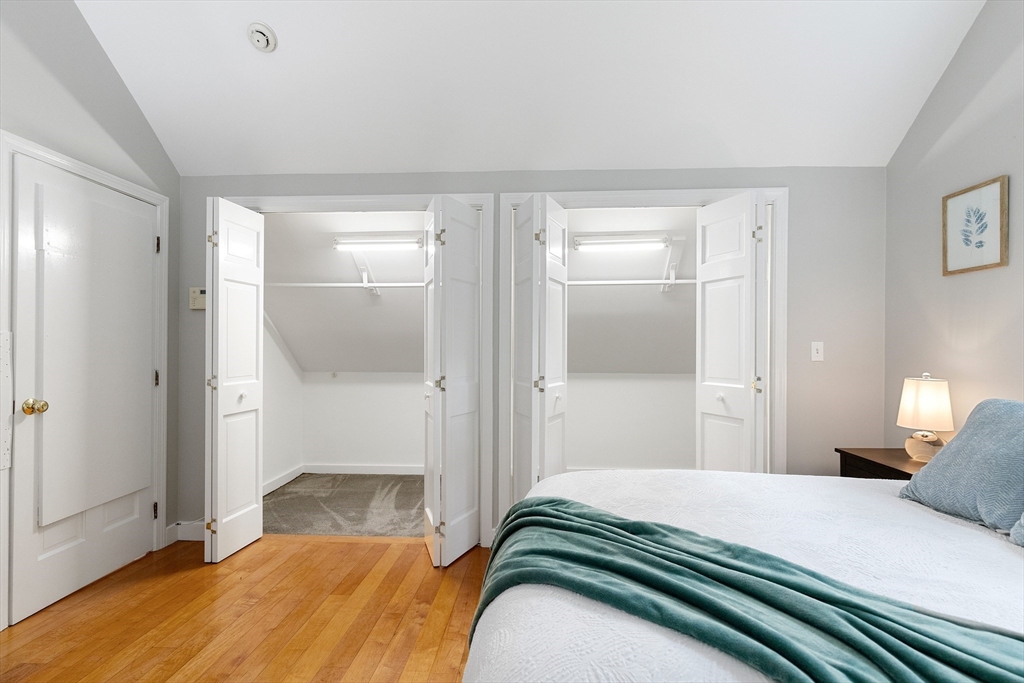 148 Wood Street, Unit 4 Lexington, MA 02421 - Photo 14 of 26 a bedroom with a bed and a mirror