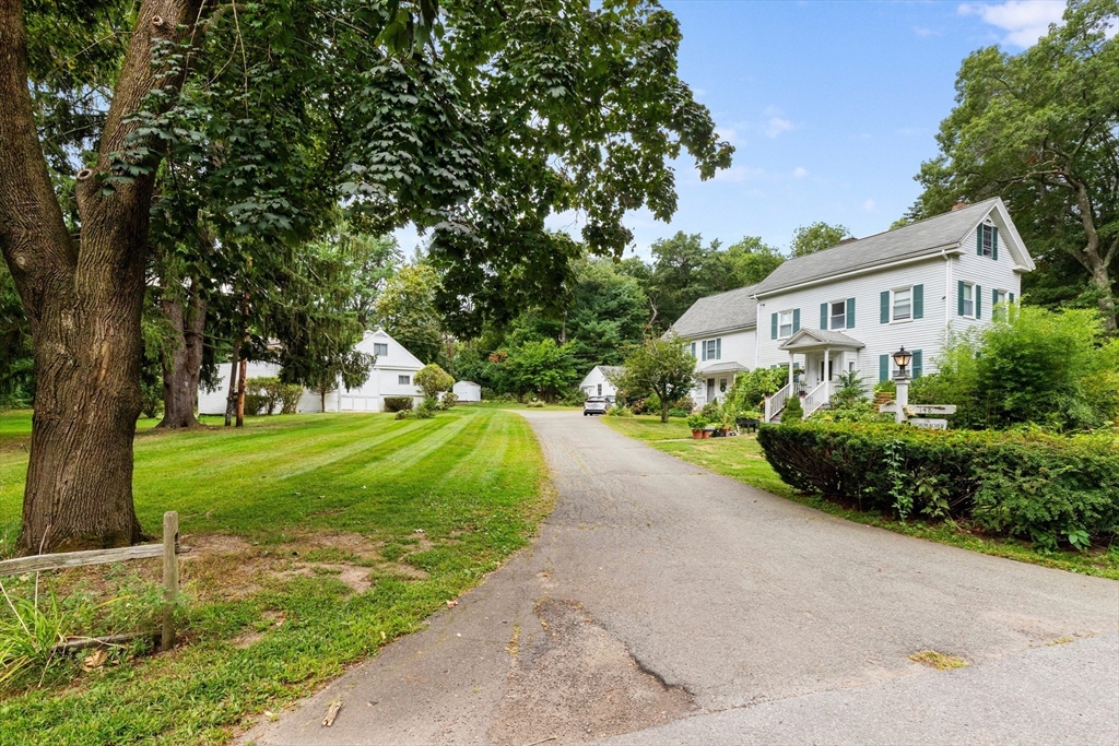 148 Wood Street, Unit 4 Lexington, MA 02421 - Photo 25 of 26 a front view of a house with a yard