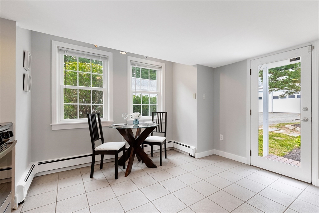 148 Wood Street, Unit 4 Lexington, MA 02421 - Photo 5 of 26 a view of a dining room with furniture and a window