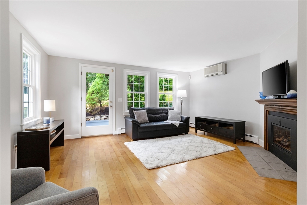 148 Wood Street, Unit 4 Lexington, MA 02421 - Photo 7 of 26 a living room with furniture and a flat screen tv