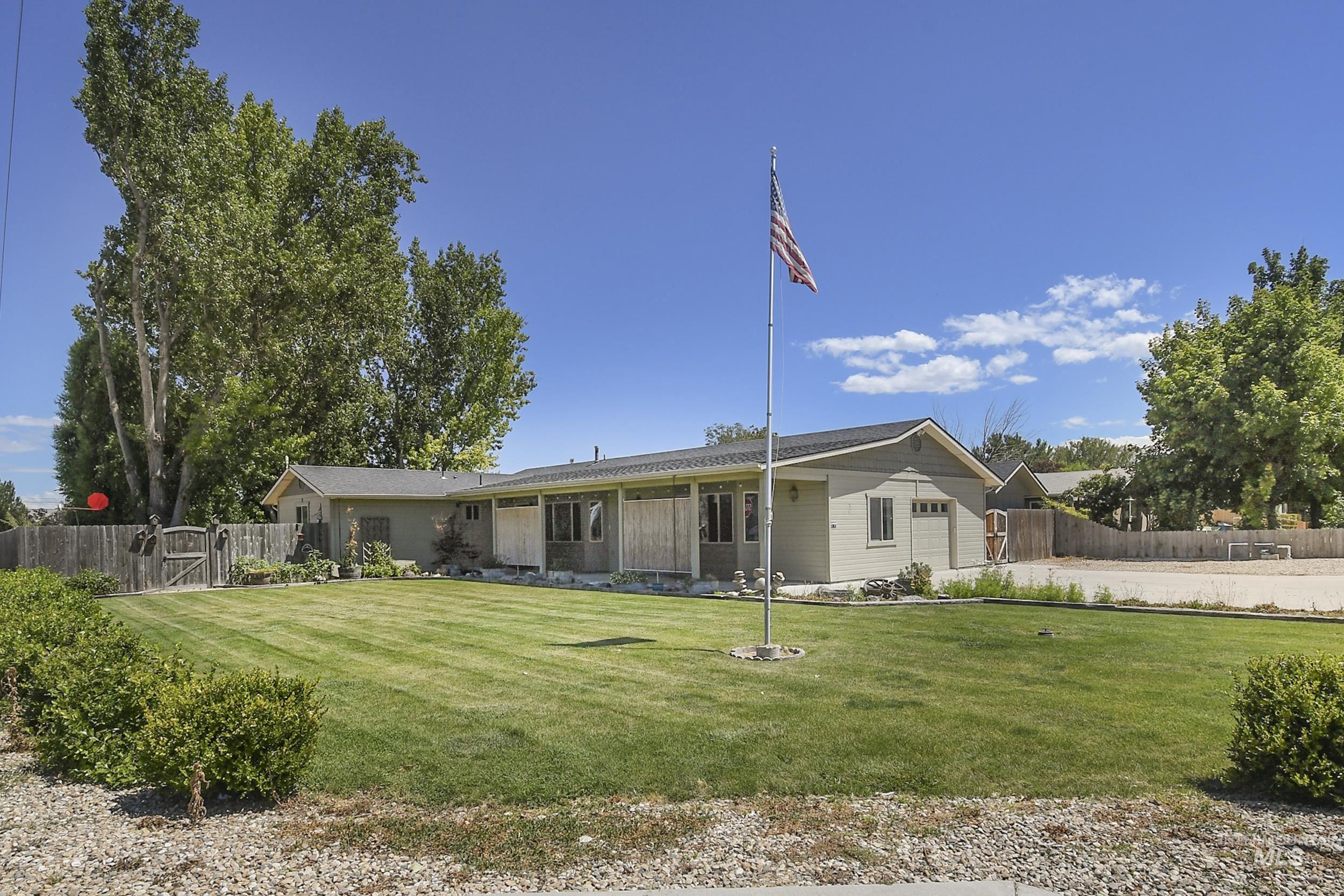 1108 East Ustick Road Caldwell, ID 83607 - Photo 1 of 30 Ranch-style exterior with a low-pitch roofline, light-colored siding, and a prominent flagpole