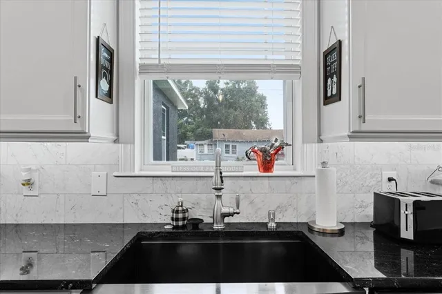 a kitchen with a sink and cabinets