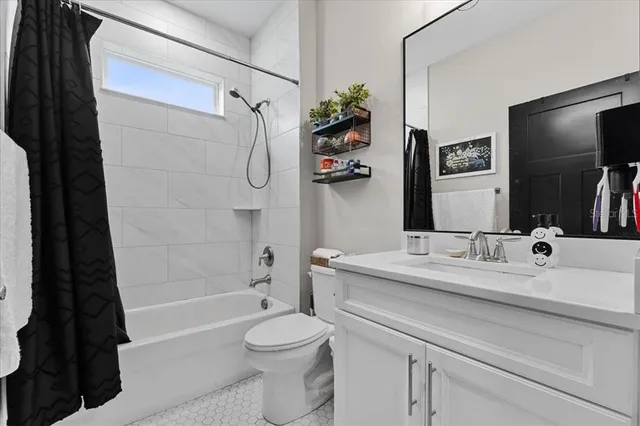 a bathroom with a sink a toilet a tub and shower