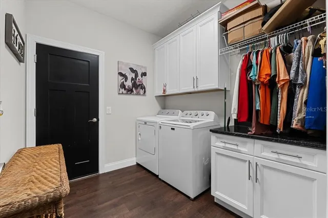a view of walk in closet with clothes