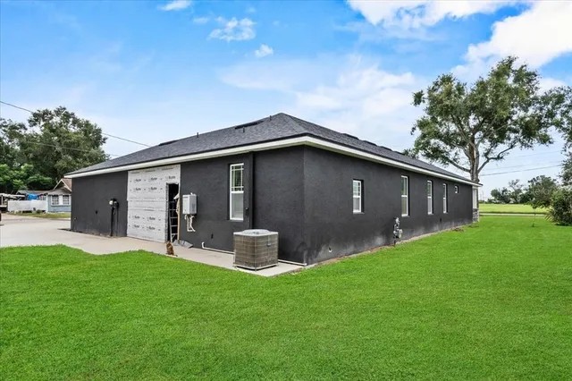 a front view of house with backyard and green space