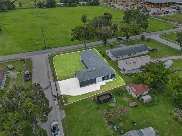 an aerial view of a house with a yard
