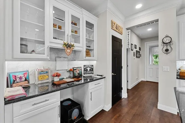 a kitchen with a sink dishwasher and a refrigerator with wooden floor