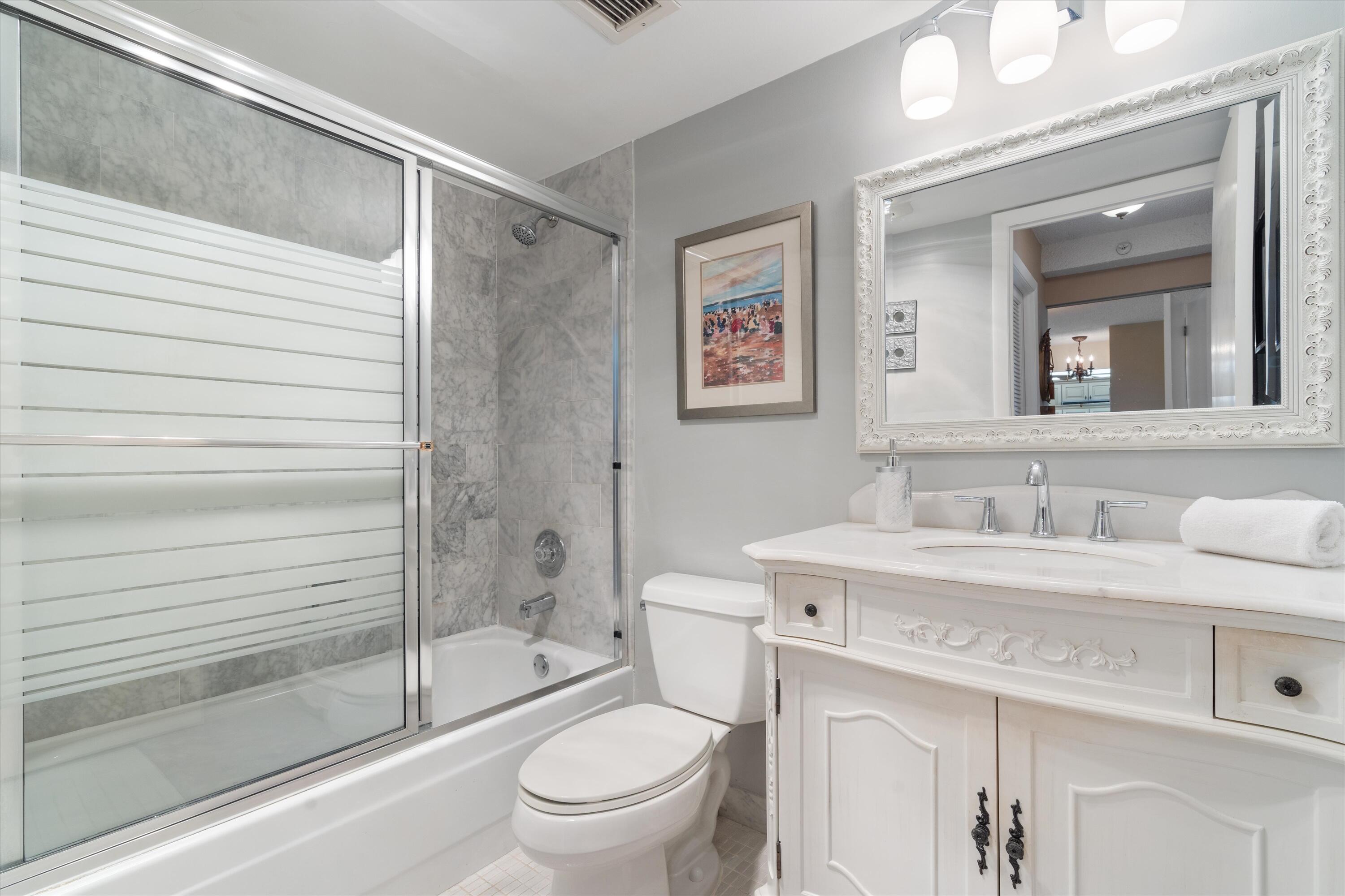 4505 South Ocean Boulevard, Unit 904 Highland Beach, FL 33487 - Photo 11 of 39 a bathroom with a sink toilet and shower