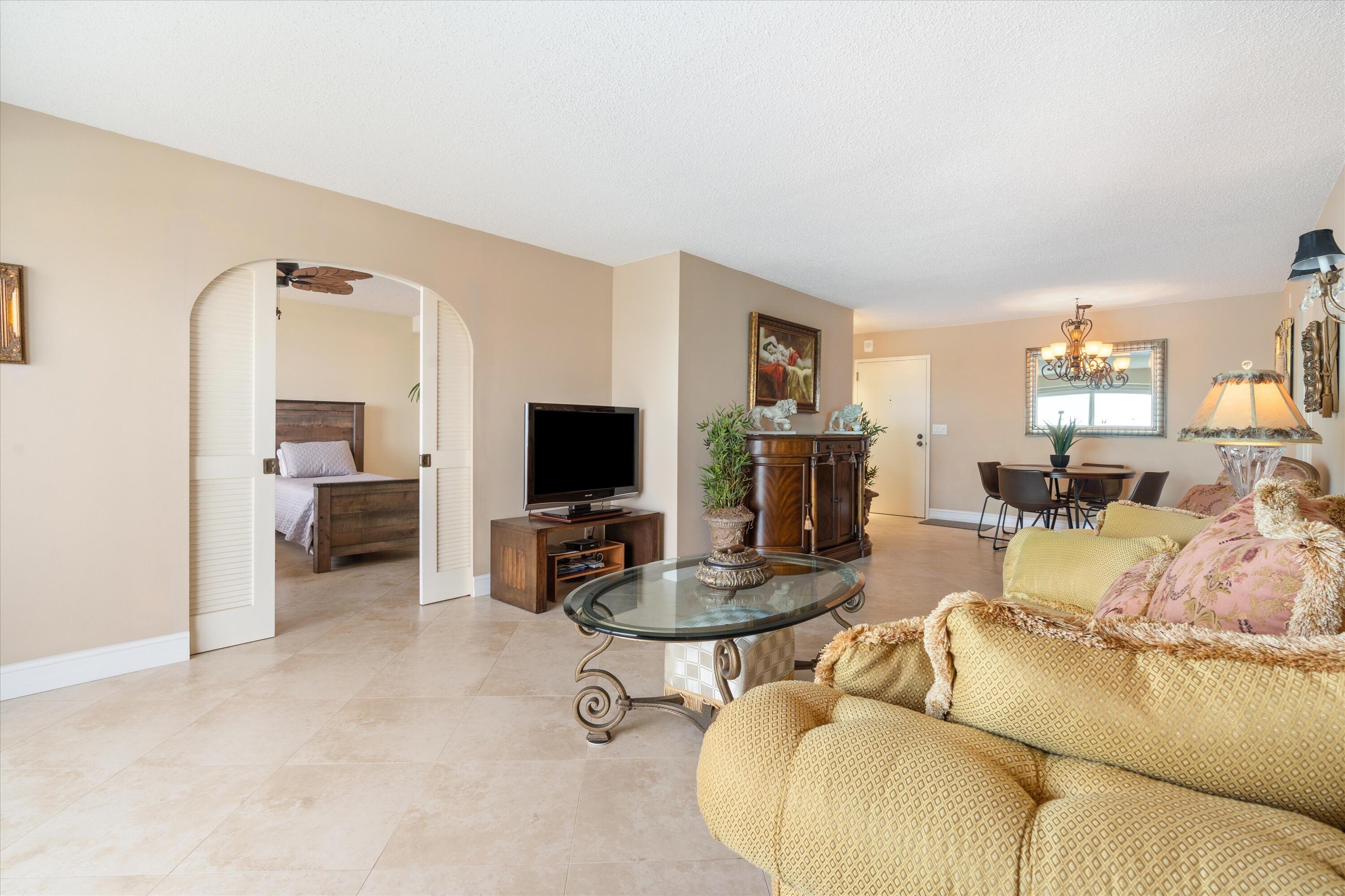 4505 South Ocean Boulevard, Unit 904 Highland Beach, FL 33487 - Photo 16 of 39 a living room with furniture and a flat screen tv