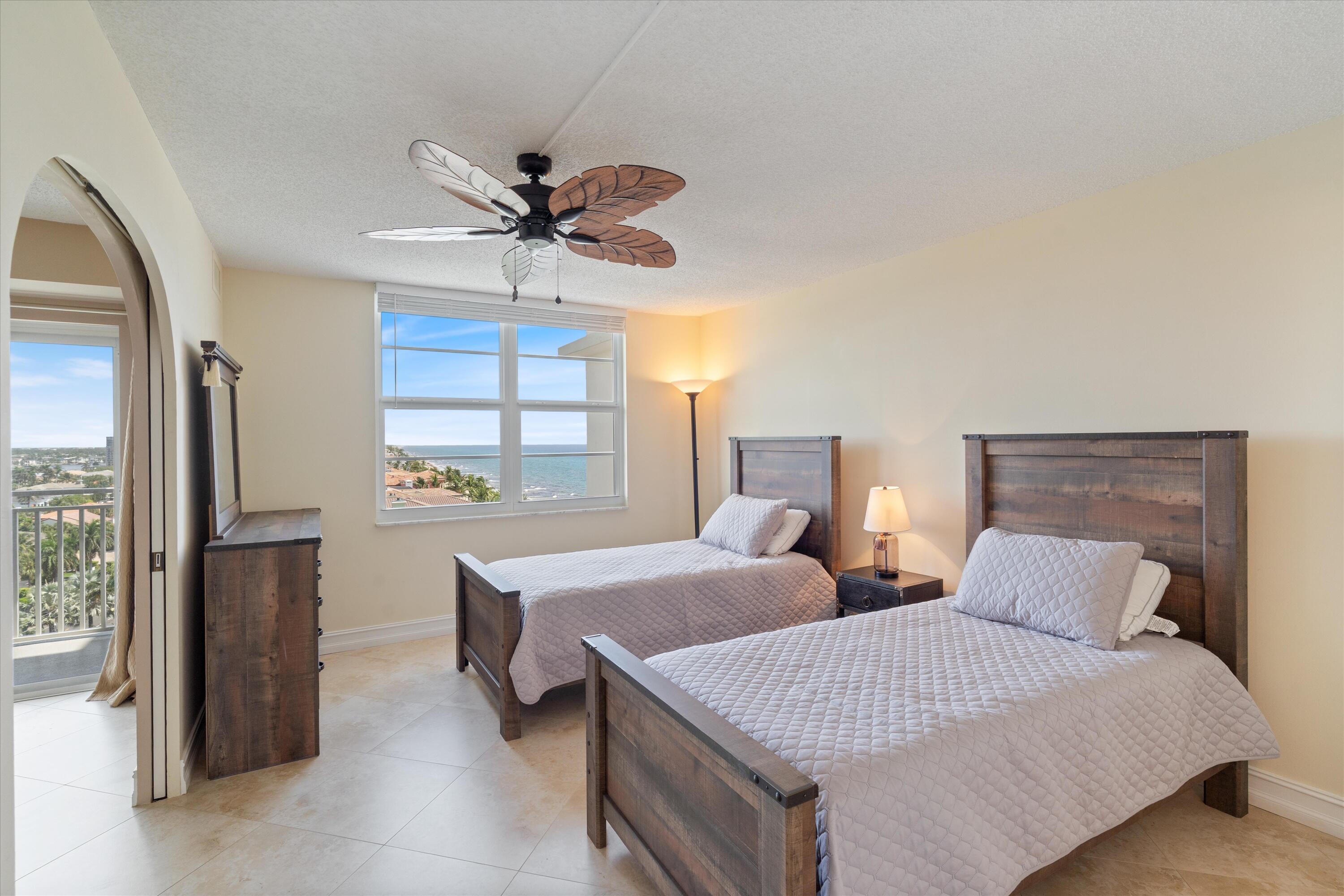 4505 South Ocean Boulevard, Unit 904 Highland Beach, FL 33487 - Photo 17 of 39 a bedroom with two beds and windows