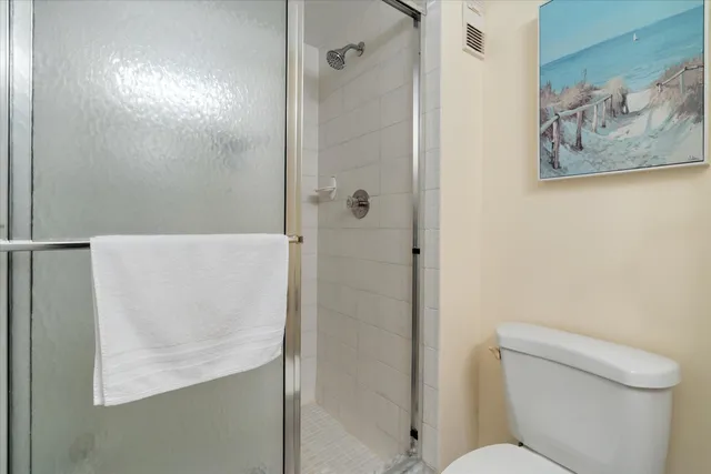 a bathroom with a toilet and a shower