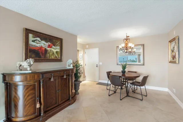a view of a dining room with furniture and chandelier