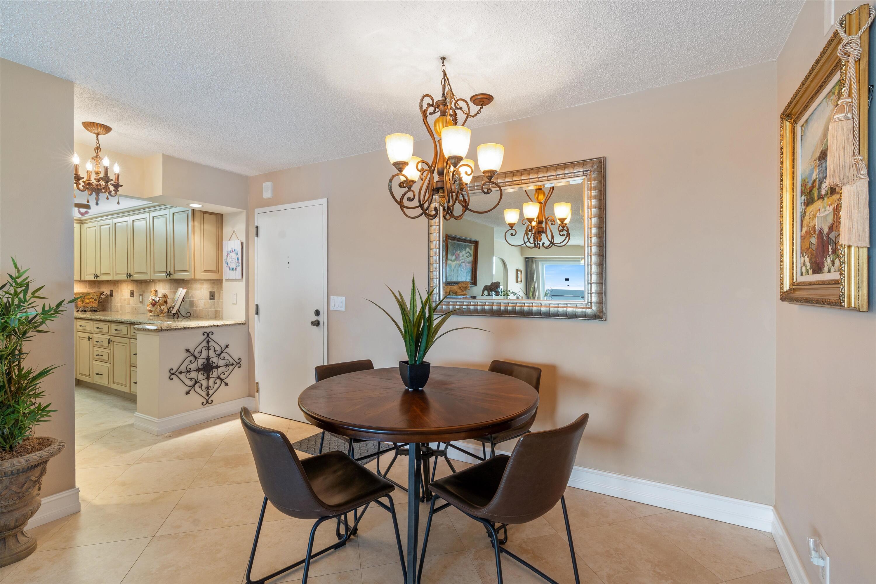 4505 South Ocean Boulevard, Unit 904 Highland Beach, FL 33487 - Photo 24 of 39 a dining room with furniture and chandelier