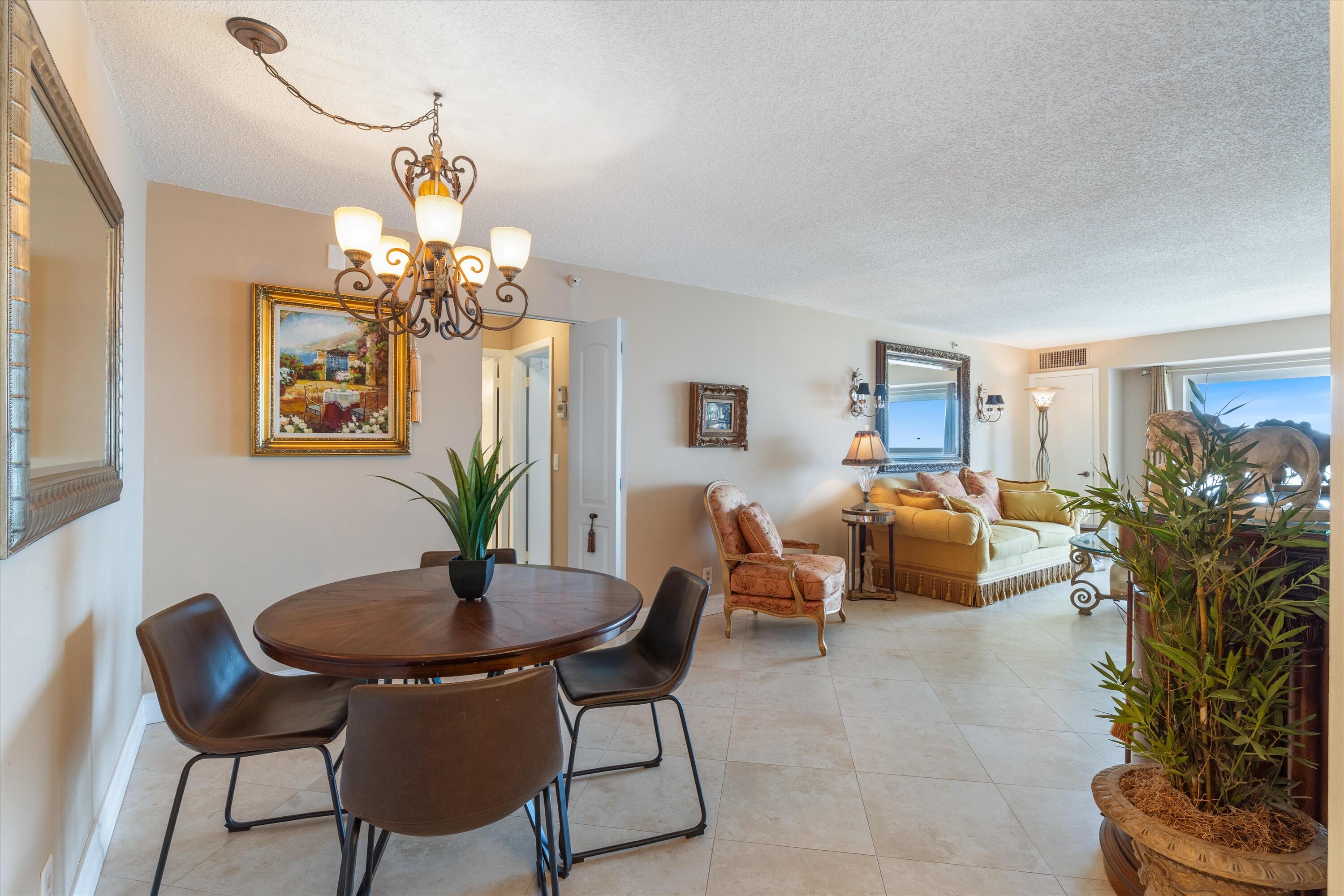 4505 South Ocean Boulevard, Unit 904 Highland Beach, FL 33487 - Photo 27 of 39 a living room with furniture and a chandelier