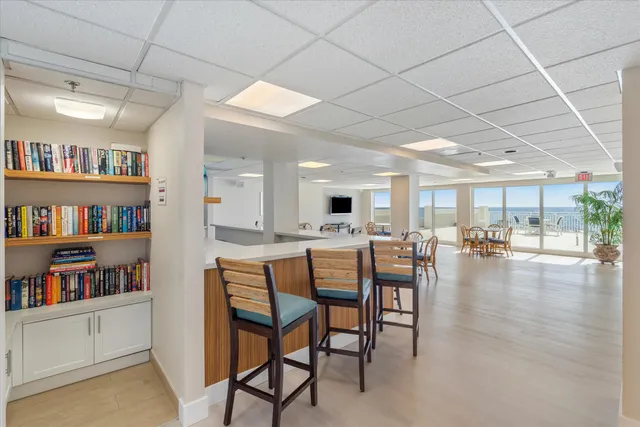 a dining room with furniture and a book shelf